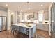 Bright kitchen with an island, stainless steel appliances, pendant lights, white cabinets, and hardwood floors at 1419 Coretta Bnd, Atlanta, GA 30318
