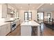 Open-concept kitchen featuring a large island, stainless steel appliances, and hardwood floors at 1419 Coretta Bnd, Atlanta, GA 30318