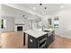 Modern kitchen boasts stainless appliances, farmhouse sink, quartz counters, and view to the living room at 1419 Coretta Bnd, Atlanta, GA 30318