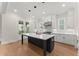 Open kitchen with white cabinetry, a black kitchen island and stainless steel appliances at 1419 Coretta Bnd, Atlanta, GA 30318