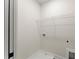 A small and functional laundry room with a wire shelf and a water hookup ready for appliances at 1419 Coretta Bnd, Atlanta, GA 30318