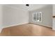 Bright living room featuring hardwood floors, neutral walls, and a stylish light fixture at 1419 Coretta Bnd, Atlanta, GA 30318