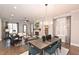 Open-concept layout featuring a modern dining set and a cozy living area with fireplace at 1419 Coretta Bnd, Atlanta, GA 30318