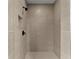 Modern tiled shower stall featuring gray tiling, a rainfall shower head, and a built-in shelf at 1419 Coretta Bnd, Atlanta, GA 30318