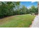 Spacious backyard with lush lawn and mature trees providing privacy and shade at 1934 Acorn Ln, Dacula, GA 30019