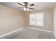 A cozy bedroom with a ceiling fan and a large window with bright natural light at 1934 Acorn Ln, Dacula, GA 30019