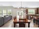 Open-concept dining and kitchen area with modern lighting and breakfast bar at 1934 Acorn Ln, Dacula, GA 30019