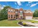 Beautiful two-story brick home with a lush lawn and landscaped garden beds at 1934 Acorn Ln, Dacula, GA 30019