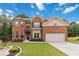 Charming two-story brick home with a well-manicured lawn and attached two-car garage at 1934 Acorn Ln, Dacula, GA 30019