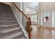 Welcoming foyer featuring a staircase, hardwood floors, and abundant natural light streaming through the front door at 1934 Acorn Ln, Dacula, GA 30019