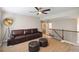 Comfortable living room with large TV, stylish furniture, ceiling fan, and view of stairway at 1934 Acorn Ln, Dacula, GA 30019