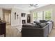 Comfortable living room featuring a fireplace, ceiling fan, and lots of natural light at 1934 Acorn Ln, Dacula, GA 30019