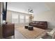 Bright living room with large TV, stylish furniture, ceiling fan, and large windows at 1934 Acorn Ln, Dacula, GA 30019