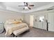 Inviting main bedroom featuring a tray ceiling, sitting area, and neutral decor at 1934 Acorn Ln, Dacula, GA 30019
