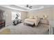Spacious main bedroom with tray ceilings, ceiling fan, exercise machine, and sitting area at 1934 Acorn Ln, Dacula, GA 30019