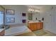 Bright bathroom with double sinks, white cabinets, tile flooring and large tub at 3020 Crooked Stick Dr, Cumming, GA 30041
