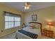 Cozy bedroom with a full bed, ceiling fan, and a window providing natural light at 3020 Crooked Stick Dr, Cumming, GA 30041