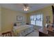 Bedroom with a ceiling fan, yellow walls, carpet flooring, and window with drapes at 3020 Crooked Stick Dr, Cumming, GA 30041