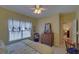 Bedroom with yellow walls, carpet floor, white curtains, and a ceiling fan at 3020 Crooked Stick Dr, Cumming, GA 30041