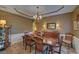 Elegant dining room with a tray ceiling, chandelier, and hardwood floors, perfect for entertaining at 3020 Crooked Stick Dr, Cumming, GA 30041