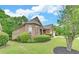 Well-manicured front lawn, brick and siding details and an attached two car garage at 3020 Crooked Stick Dr, Cumming, GA 30041
