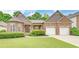Charming brick home with a well-manicured lawn and a two-car garage, perfect for Gathering living at 3020 Crooked Stick Dr, Cumming, GA 30041