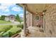Charming porch with stone details, elegant lighting, and landscaping, perfect for enjoying the outdoors at 3020 Crooked Stick Dr, Cumming, GA 30041