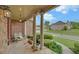 Inviting front porch with stone flooring, decorative pillars, and cozy seating, ideal for relaxing at 3020 Crooked Stick Dr, Cumming, GA 30041