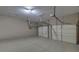 Spacious garage featuring dual garage doors and a concrete floor at 3020 Crooked Stick Dr, Cumming, GA 30041