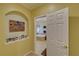 Hallway with arched detailing, shelving, and a view of the bathroom at 3020 Crooked Stick Dr, Cumming, GA 30041