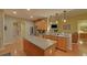 Modern kitchen with island, stainless steel appliances, and hardwood floors flows into the living area at 3020 Crooked Stick Dr, Cumming, GA 30041