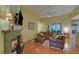 Bright living room featuring a fireplace, hardwood floors, and comfortable leather seating arrangement at 3020 Crooked Stick Dr, Cumming, GA 30041