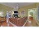 Spacious living room showcases a fireplace, wood floors, and a plush leather sofa, perfect for relaxation at 3020 Crooked Stick Dr, Cumming, GA 30041