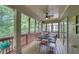 Screened patio with fan features a dining table and offers views of the surrounding trees at 3020 Crooked Stick Dr, Cumming, GA 30041