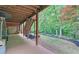 Covered patio with views of backyard, access to an outdoor staircase, lush landscaping at 3020 Crooked Stick Dr, Cumming, GA 30041