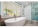 Modern bathroom showcasing a soaking tub and walk-in shower at 3020 Parkridge Ne Dr, Brookhaven, GA 30319