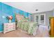 Bright bedroom featuring unique accent wall, french doors, and a view to the outside at 3020 Parkridge Ne Dr, Brookhaven, GA 30319