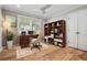 Inviting home office with natural light, built-in shelving, and wood floors at 3020 Parkridge Ne Dr, Brookhaven, GA 30319