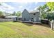Spacious backyard with a wooden deck, partially fenced and with lush greenery all around at 4971 Sharp Way, Duluth, GA 30096