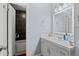Bathroom with tiled shower/tub, vanity with white sink and cabinets, and a large mirror at 4971 Sharp Way, Duluth, GA 30096