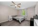 This bedroom features a ceiling fan, neutral walls, carpet, and a window with natural light at 4971 Sharp Way, Duluth, GA 30096