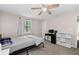 Bedroom with neutral walls, carpet, window, desk, shelving and ceiling fan at 4971 Sharp Way, Duluth, GA 30096