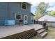 Wooden deck with a grill and steps leading down to the backyard. The house is painted gray at 4971 Sharp Way, Duluth, GA 30096