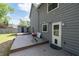 Wooden deck featuring a grill and an entry door to the house. The house is painted gray at 4971 Sharp Way, Duluth, GA 30096