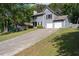 Charming two-story home featuring a two-car garage, second story balcony, and long driveway on a large lot at 4971 Sharp Way, Duluth, GA 30096