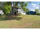 Two-story home featuring a two-car garage, second story balcony and a spacious yard with mature shade trees at 4971 Sharp Way, Duluth, GA 30096