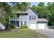 Two-story home featuring a two-car garage, second story balcony, and a well-maintained front lawn with shrubs at 4971 Sharp Way, Duluth, GA 30096