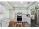 Well-lit kitchen featuring stainless steel appliances and stylish countertops at 4971 Sharp Way, Duluth, GA 30096