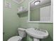 Cozy powder room featuring a pedestal sink and decorative mirror at 4971 Sharp Way, Duluth, GA 30096