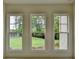 View of the backyard from inside of the house through three large windows at 11305 Knollwood Bend, Johns Creek, GA 30097